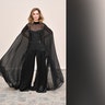 Calista Flockhart stunned in a flowing black strapless jumpsuit with sleeves draping down to the floor, while at the Ashi Studio fashion show.