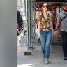 Dakota Johnson kept it casual while on location for her latest project "Materialists," in a semi-sheer floral shirt and jeans.