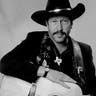 Kinky Friedman posing with his guitar