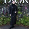 Lilly Collins at the Dior fashion show wearing black from head to toe.