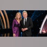 Pat Sajak and Vanna White wearing purple and black