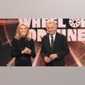 Vanna White and Pat Sajak on the set of "Wheel of Fortune" wearing black