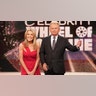 Pat Sajak in a suit and Vanna White in a red dress