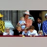 Princess Diana often stood near with the royal children. She can be seen here holding baby Prince Harry, and standing behind Prince William.
