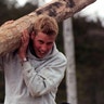 Prince William carrying a big log.