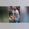 Prince William and Princess Diana cuddled while watching a polo match.