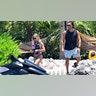 Sweeney excitedly approaches a jet ski, with her fiancé, Jonathan Davino, looking on.