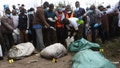 Sacks with human remains are seen after being removed from a quarry in Mukuru Kwa Njenga area in Nairobi, Kenya on July 13, 2024. Police in Kenya said Monday they have arrested the main suspect after nine dismembered bodies of women were found in a quarry in the capital, Nairobi.