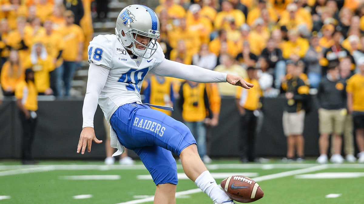 Kyle Ulbrich punts the football