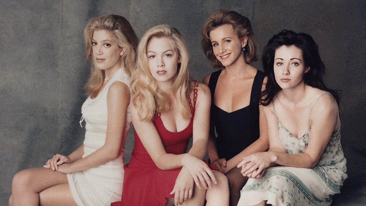 Tori Spelling, Jennie Garth, Gabrielle Carteris, and Shannen Doherty pose for a picture as the cast of "Beverly Hills: 90210"