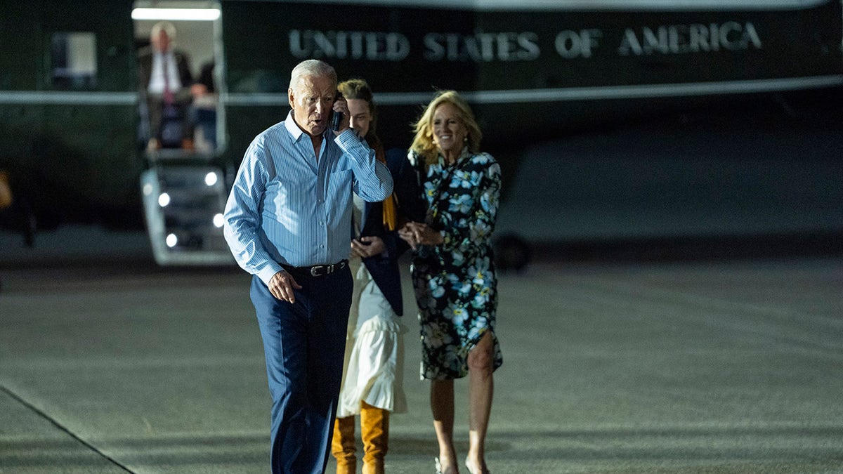 Biden connected  the telephone  walking to committee  Air Force One aft  debate