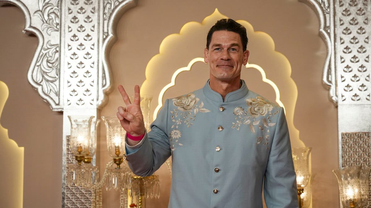 John Cena makes a peace sign at an Indian wedding