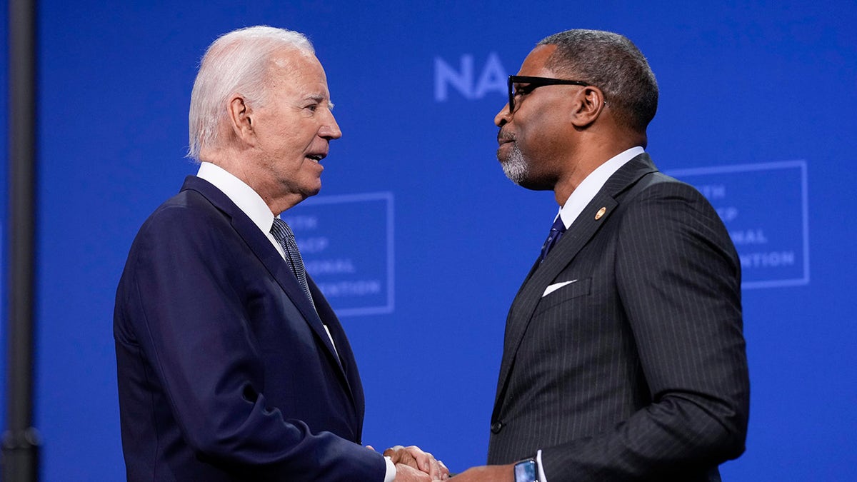 Biden shakes hands with NAACP President Derrick Johnson