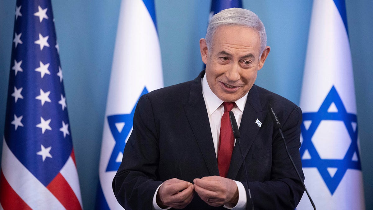 Netanyahu file image in front of Israeli flag