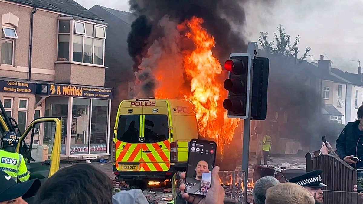 Police van on fire at riots in Southport, England
