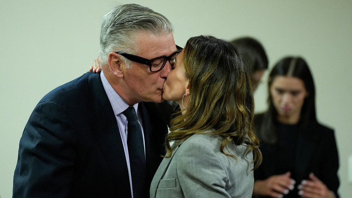 Hilaria Baldwin kisses her husband US actor Alec Baldwin during his trial