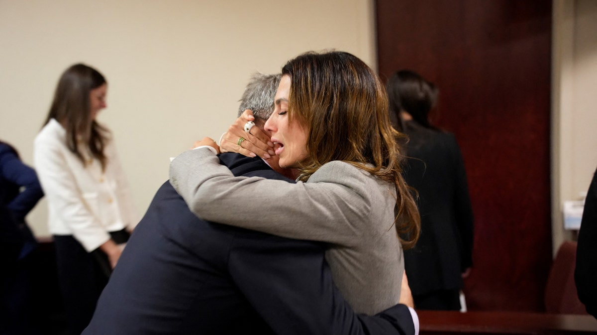 Hilaria and Alec Baldwin embrace in court