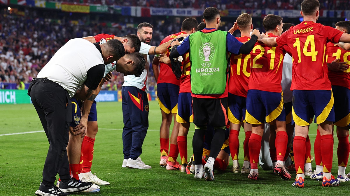 Spain players help Alvaro Morata