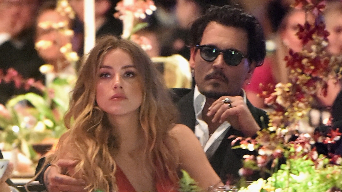Amber Heard and Johnny Depp attend an event