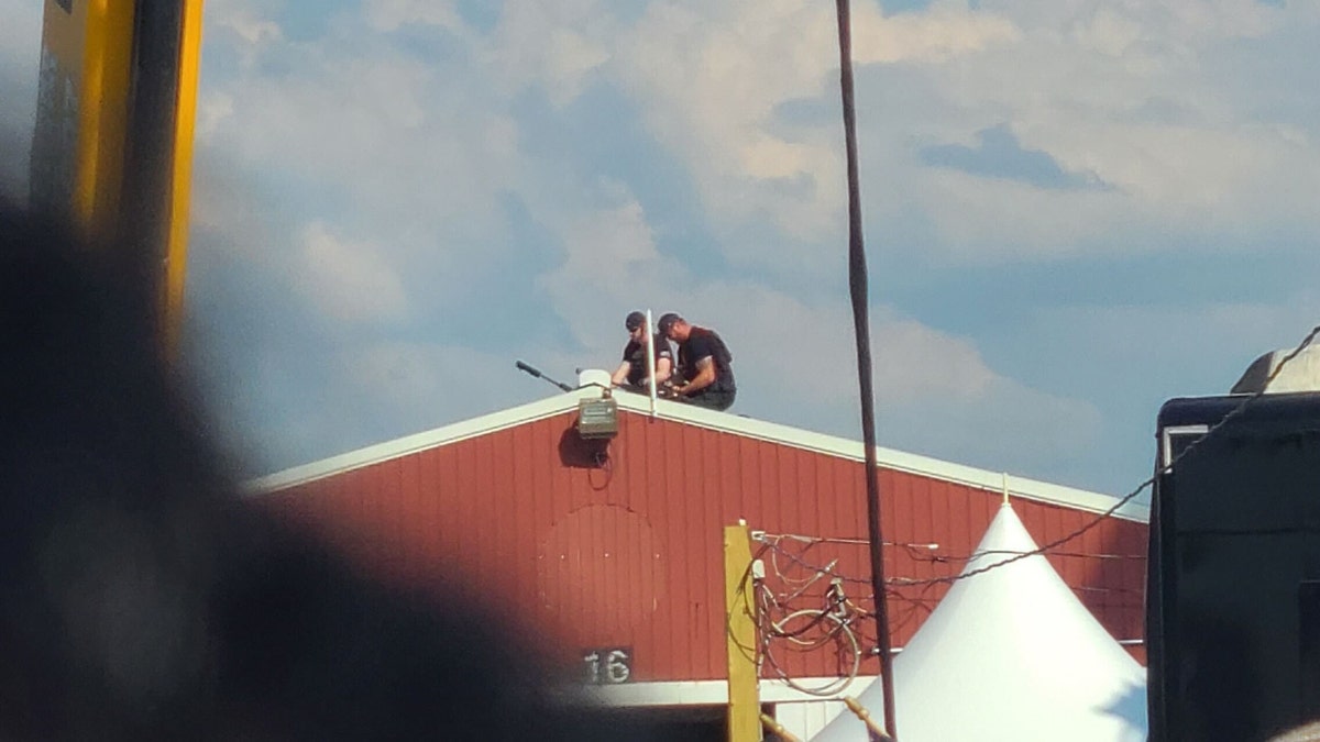 Law enforcement on the roof of a red building at the July 13 Trump rally