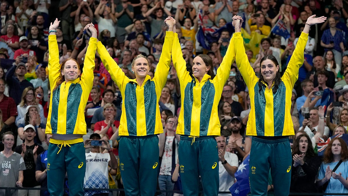 Australian swimmers celebrate on the podium