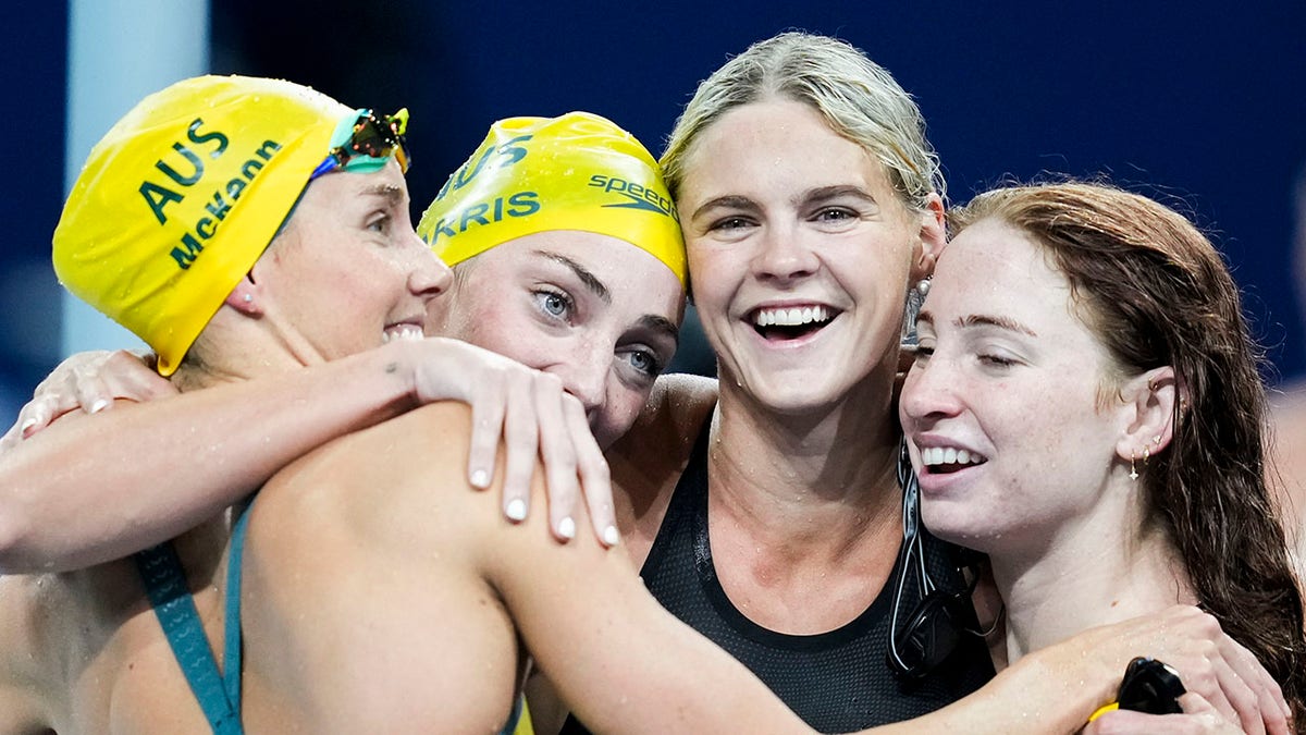 Australian swimmers hug in jubilation