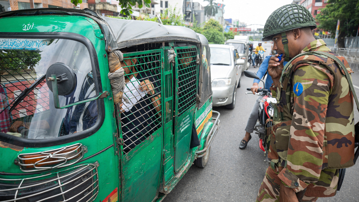 Commuter shows curfew pass to soldier