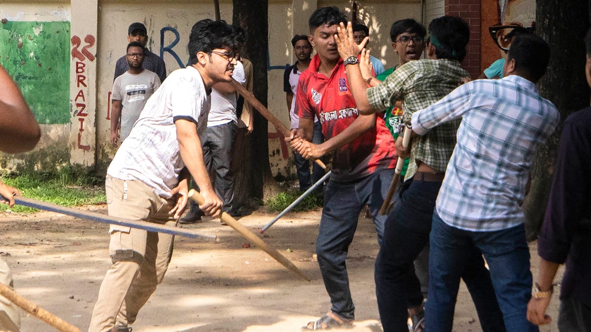 Students wielding wooden sticks charge at others at at Jahangir Nagar University.