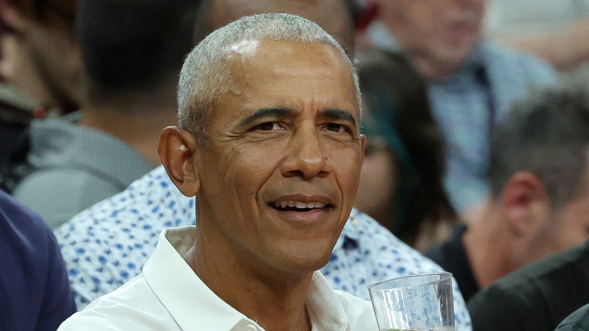 Barack Obama sits courtside