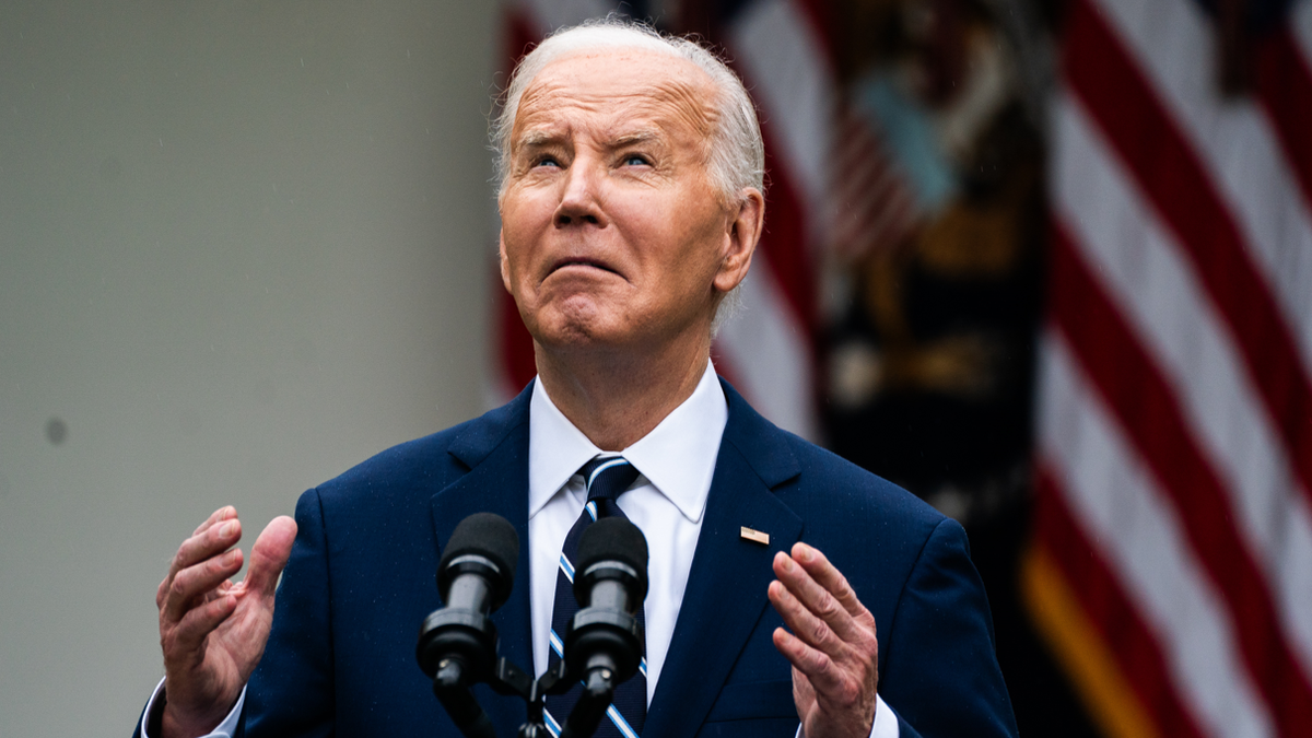 WASHINGTON, DC May 14, 2024: US President Joe Biden looks up at the rain during his remarks during an event to promote American investments and jobs in the Rose Garden of the White House on Tuesday May 14, 2024.