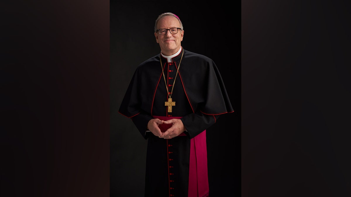 Bishop Robert Barron wearing traditional vestments and a crucifix