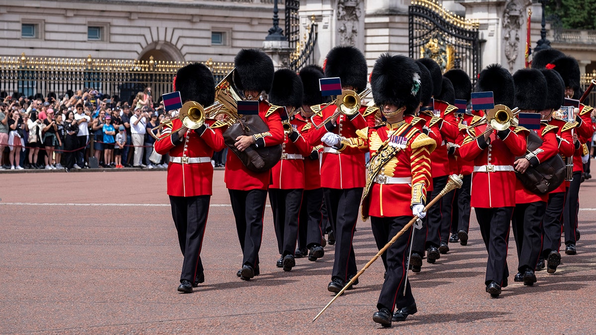Tourists and domestic visitors at Buckingham Palace watch in huge numbers as Changing of the Guard takes place of the King's Guard comprised of Coldstream Guards, the Band of the Coldstream Guards and the Scots Guards