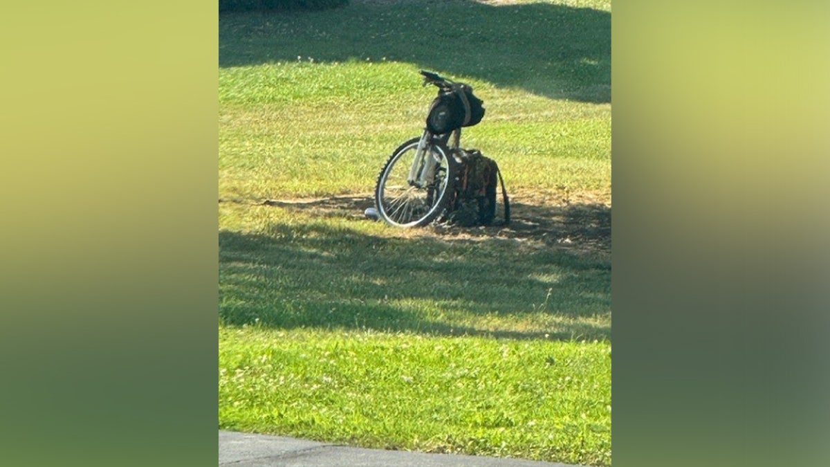 An evidence photo shows the bicycle and backpack left by Thomas Crooks before his attempted assassination of former President Donald Trump
