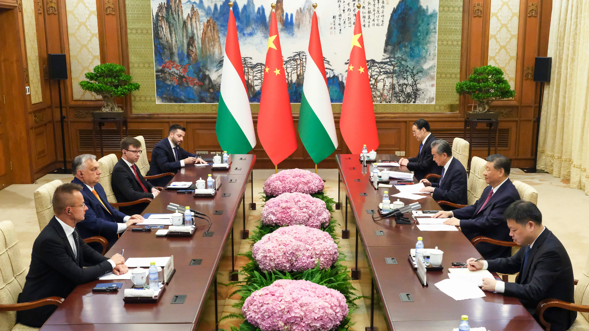 Hungarian Prime Minister Viktor Orban, second left, talks to Chinese President Xi Jinping