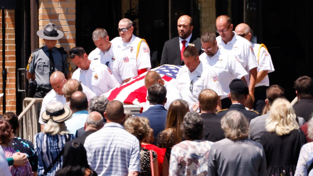 Firefighters carry the casket of Corey Comperatore