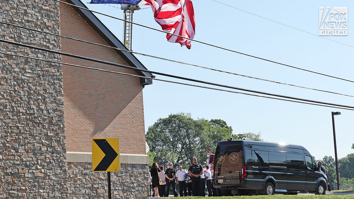 The casket of Corey Comperatore is carried into Cabot United Methodist Church