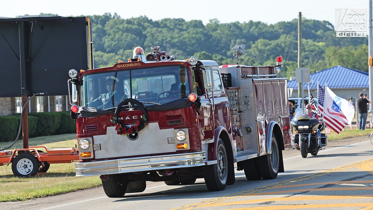 A firetruck carrying the body of Corey Comperatore travels Cabot United Methodist Church in Cabot