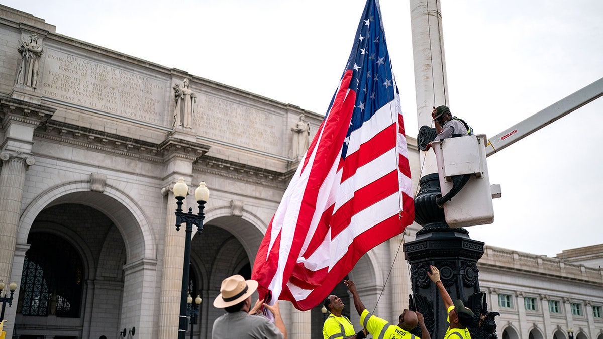 National Park Service workers put up US flag at Union Station