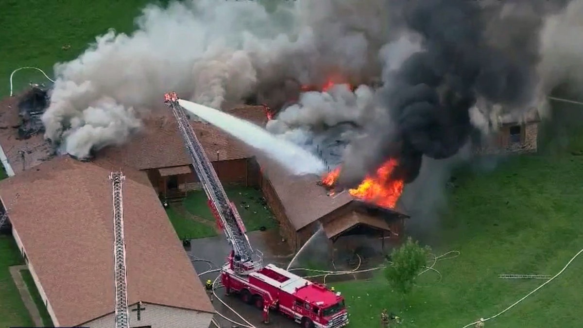 Aerial view of church fire in roof blazing