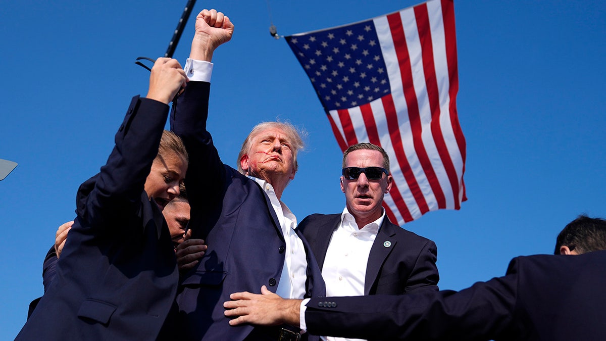 Republican presidential candidate former President Donald Trump is surrounded by U.S. Secret Service agents at a campaign rally