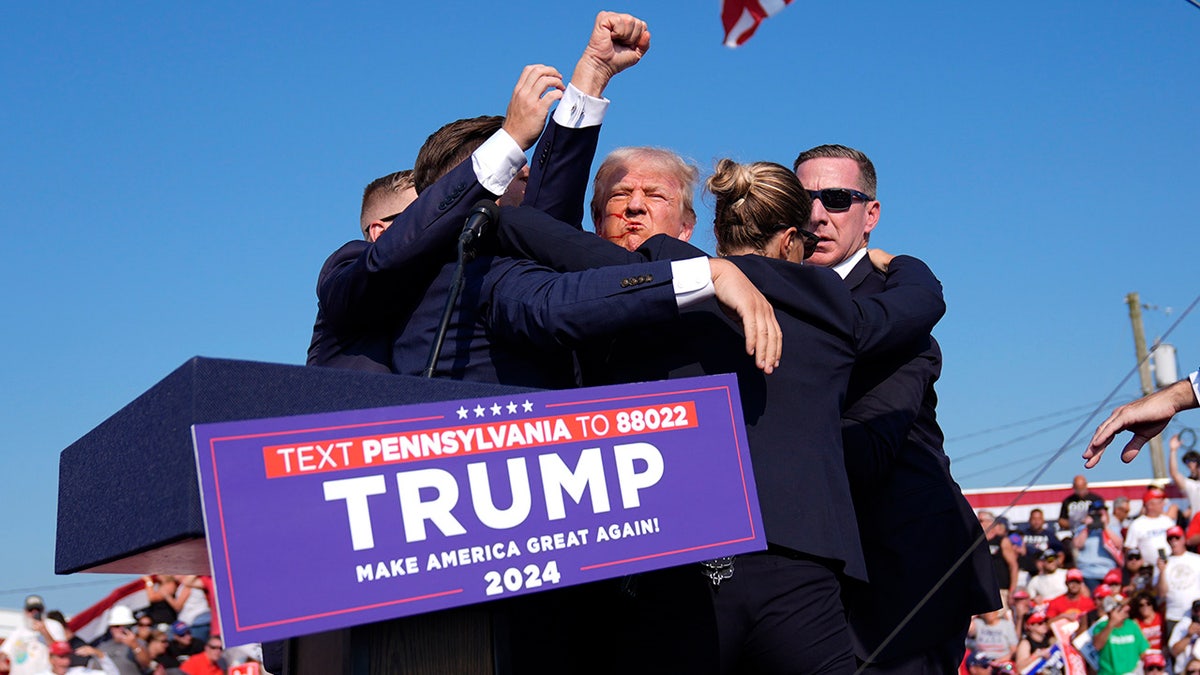 Republican presidential candidate former President Donald Trump is surrounded by U.S. Secret Service agents at a campaign rally