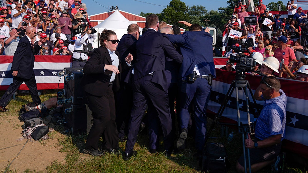Donald Trump is surrounded by U.S. Secret Service agents at a campaign rally