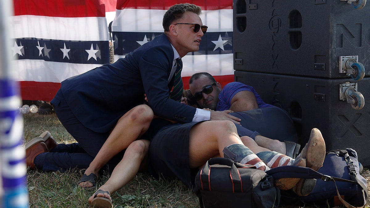 A Secret Service member and members of the crowd are seen at a rally for Republican presidential candidate former President Donald Trump.