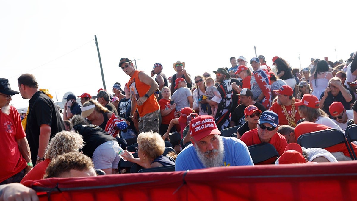 The crowd reacts after shots were fired at republican presidential candidate former President Donald Trump's rally