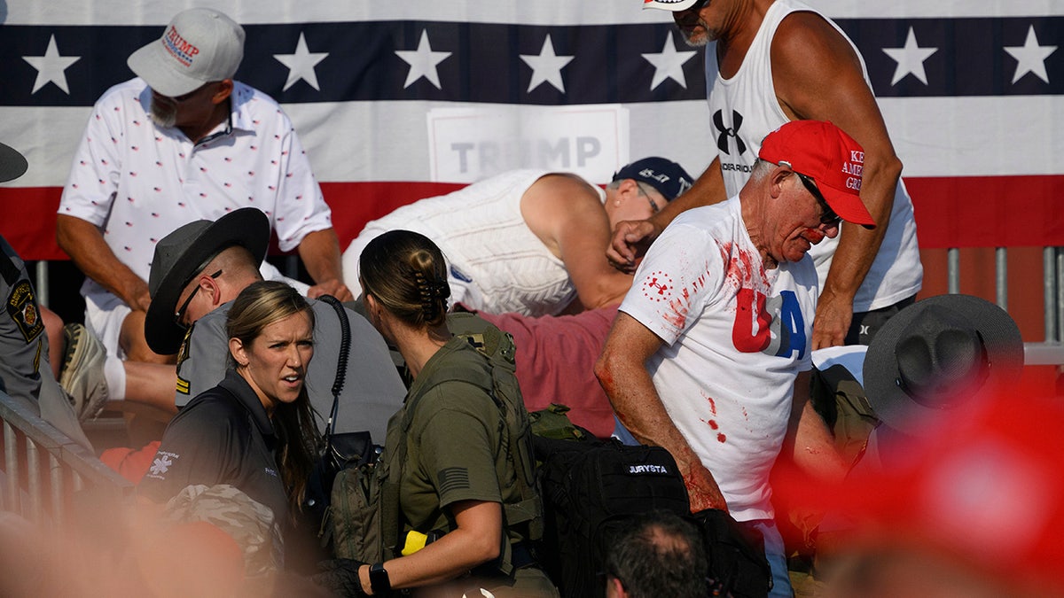 Attendees disperse after gunshots were heard during a campaign rally for Republican presidential candidate former US President Donald Trump