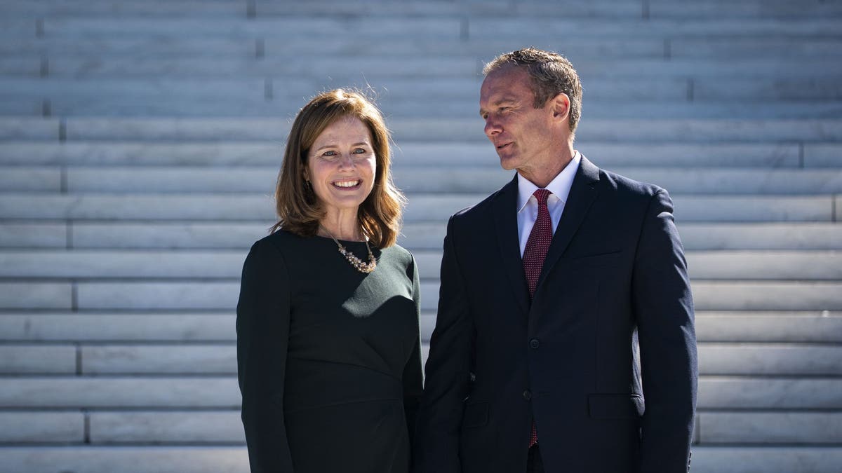 Amy Coney Barrett with husband outside steps to Supreme Court
