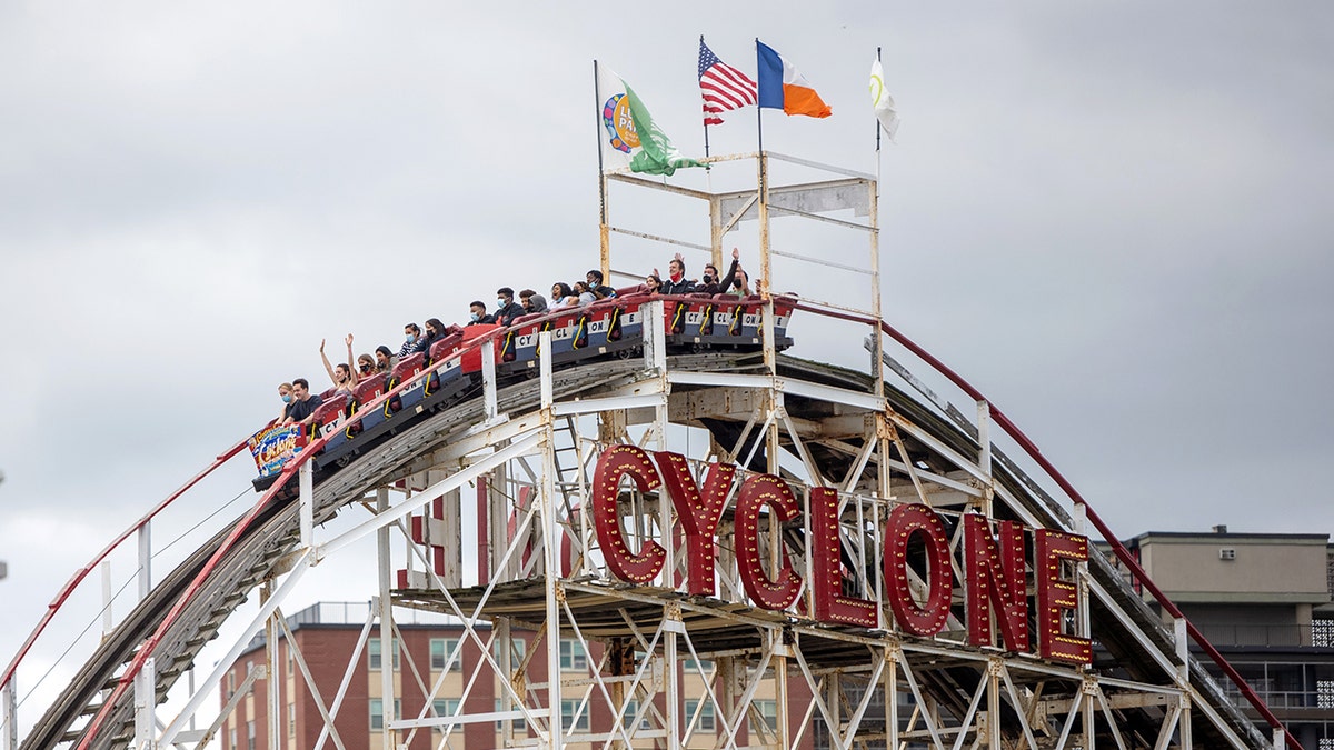 People riding the Cyclone at Coney Island.