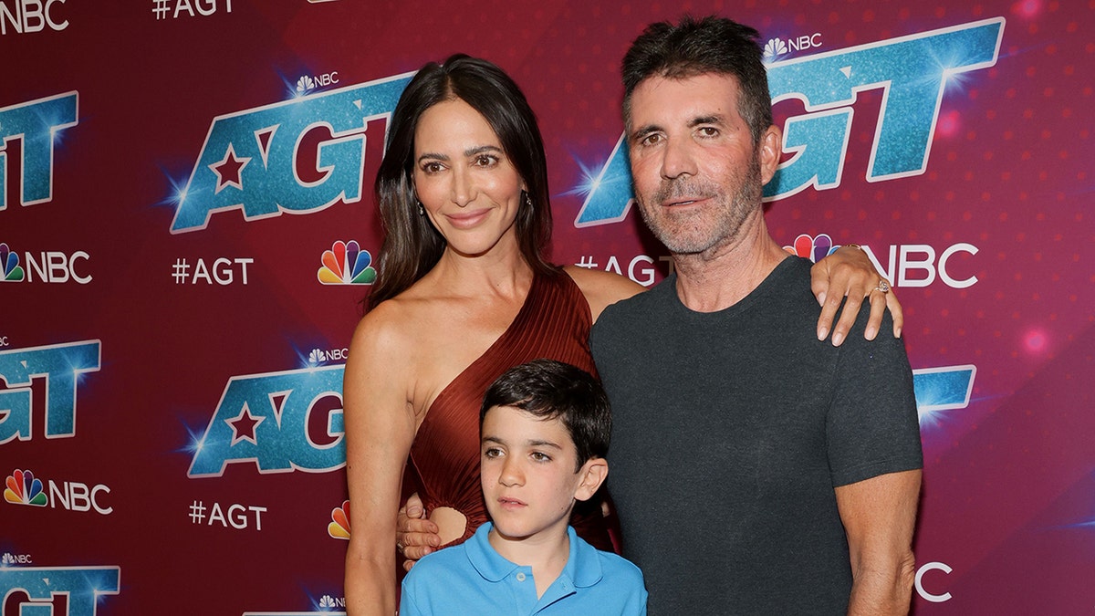 Lauren Silverman and Simon Cowell posing with their son Eric