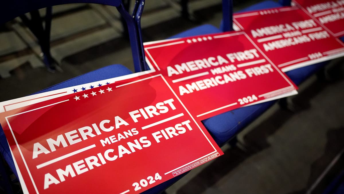 Signs reading "America First Means America First" are seen during preparations for the fourth day of the Republican National Convention at the Fiserv Forum on July 18, 2024, in Milwaukee, Wisconsin. (Andrew Harnik/Getty Images)