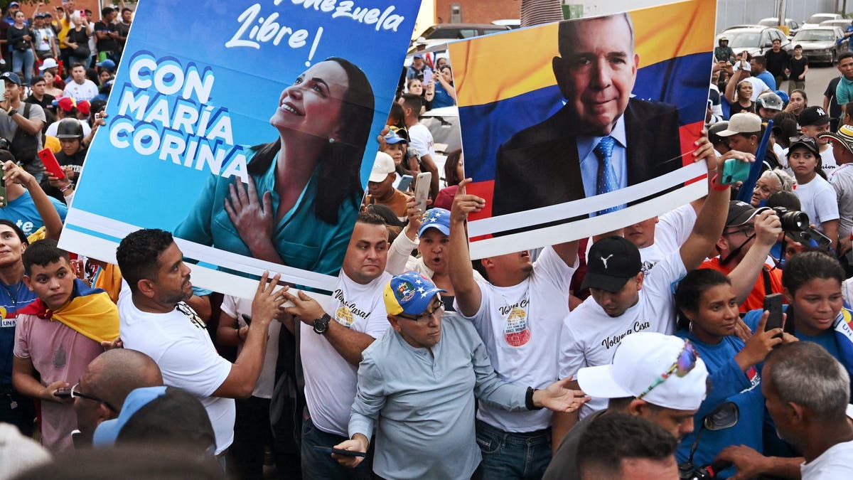 Venezuela opposition parties hold large signs
